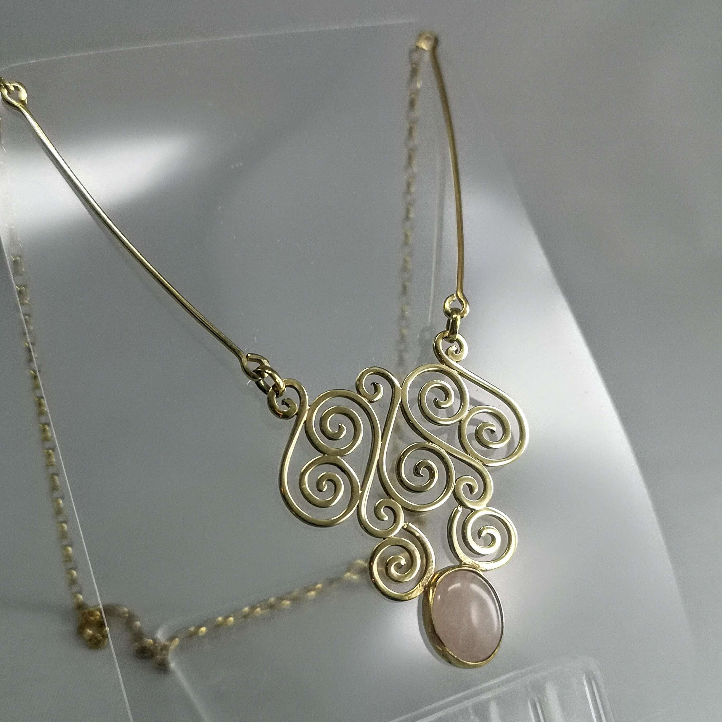 9ct Gold ornate spiral neckpiece with a beautiful rose quartz crystal